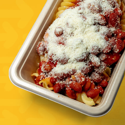 Bife de frango com molho de tomate, feijão e parmesão acompanhado com fusilli